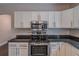 Kitchen featuring stainless steel appliances and granite counters with white cabinets at 1555 New Ne St, Atlanta, GA 30307