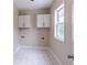 Functional laundry room with sleek white cabinetry and stylish tile flooring at 1555 New Ne St, Atlanta, GA 30307