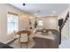 An expansive living room with large windows, a dining area, and a modern color palette with an open-concept design at 1555 New Ne St, Atlanta, GA 30307