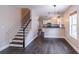 Stylish living area with hardwood floors, stairs, an open flow into the kitchen, and natural light at 1555 New Ne St, Atlanta, GA 30307
