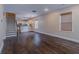 Spacious living room featuring hardwood floors and a modern open layout to kitchen at 1555 New Ne St, Atlanta, GA 30307