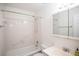 Bathroom featuring white tiles, tub-shower combo, mirrored medicine cabinet, and grab bar at 3053 Shadow Walk Ln, Tucker, GA 30084