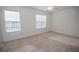 This bedroom has carpeted floors and two large windows that let in plenty of natural light at 3053 Shadow Walk Ln, Tucker, GA 30084