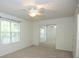 Bedroom featuring neutral carpet, ceiling fan, natural light and mirrored closet doors at 3053 Shadow Walk Ln, Tucker, GA 30084