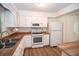 The kitchen features white cabinets, an oven and range, and stainless steel appliances at 3053 Shadow Walk Ln, Tucker, GA 30084