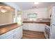 An open concept kitchen features white cabinets, wood-look countertops, and stainless steel appliances at 3053 Shadow Walk Ln, Tucker, GA 30084