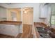 A kitchen view features a double sink, a window, and an open design to the dining area at 3053 Shadow Walk Ln, Tucker, GA 30084