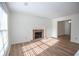 Bright living room with a brick fireplace and light-colored floors, illuminated by sunlight at 3053 Shadow Walk Ln, Tucker, GA 30084