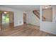 Bright living room boasts light wood floors, a ceiling fan, and sliding glass doors to the yard at 3053 Shadow Walk Ln, Tucker, GA 30084