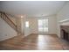 Spacious living room featuring a brick fireplace, staircase, and modern flooring, creating a comfortable atmosphere at 3053 Shadow Walk Ln, Tucker, GA 30084