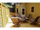 A wooden backyard deck with comfortable patio furniture and a partial lattice surround at 10815 Tuxford Dr, Alpharetta, GA 30022