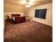 A bedroom featuring wall-to-wall carpeting, a ceiling fan, a large window, and a wooden bed frame at 10815 Tuxford Dr, Alpharetta, GA 30022