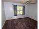 Bedroom featuring a ceiling fan, carpet, a window that brings in natural light, and blue curtains at 10815 Tuxford Dr, Alpharetta, GA 30022