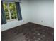 Bedroom features a large window with natural light, carpeting, and light blue paint at 10815 Tuxford Dr, Alpharetta, GA 30022