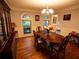 Spacious dining room featuring hardwood floors, natural light, and classic decor at 10815 Tuxford Dr, Alpharetta, GA 30022