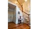 Inviting foyer with a curved staircase, hardwood floors, and elegant wainscoting details at 10815 Tuxford Dr, Alpharetta, GA 30022