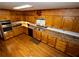 Large kitchen with wood cabinets, laminate countertops, stainless steel appliances, and hardwood floors at 10815 Tuxford Dr, Alpharetta, GA 30022