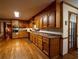 Spacious kitchen with stainless steel appliances, wood cabinets, and hardwood flooring at 10815 Tuxford Dr, Alpharetta, GA 30022