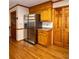 Classic kitchen featuring oak cabinets, stainless steel refrigerator, and hardwood floors at 10815 Tuxford Dr, Alpharetta, GA 30022