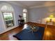 Bright living room with hardwood floors, large windows, and a classic area rug at 10815 Tuxford Dr, Alpharetta, GA 30022
