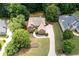 Aerial view of a home with well-manicured lawn, trees, and a long driveway at 3045 Moss Stone Lane Sw Ln, Marietta, GA 30064