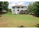 Back exterior view of the home, featuring a well-maintained lawn and an upper deck at 3045 Moss Stone Lane Sw Ln, Marietta, GA 30064