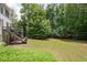 Spacious backyard featuring a lush green lawn and steps to the lower level porch at 3045 Moss Stone Lane Sw Ln, Marietta, GA 30064