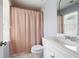 Bathroom features shower over tub with a pink curtain and a white vanity at 3045 Moss Stone Lane Sw Ln, Marietta, GA 30064
