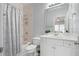 Well-lit bathroom featuring a shower over tub with a patterned curtain and a white vanity at 3045 Moss Stone Lane Sw Ln, Marietta, GA 30064