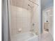 Well-lit bathroom with neutral tiles, a bathtub, and a shower with neutral-patterned curtain at 3045 Moss Stone Lane Sw Ln, Marietta, GA 30064