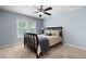 Bedroom with dark wood bed frame, neutral carpet and bright window at 3045 Moss Stone Lane Sw Ln, Marietta, GA 30064