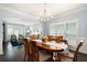 Elegant dining room featuring wainscoting, hardwood floors, and an archway to the living room at 3045 Moss Stone Lane Sw Ln, Marietta, GA 30064