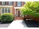 Welcoming entrance of a brick home with a wood front door and manicured landscaping at 3045 Moss Stone Lane Sw Ln, Marietta, GA 30064