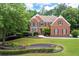 Charming home with manicured lawn and brick accents in a well-maintained front yard at 3045 Moss Stone Lane Sw Ln, Marietta, GA 30064