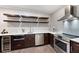 Modern kitchen featuring stainless steel appliances and floating shelves for stylish storage at 3045 Moss Stone Lane Sw Ln, Marietta, GA 30064