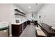Modern bar area and kitchen with dark wood cabinets, floating shelves and stainless steel appliances at 3045 Moss Stone Lane Sw Ln, Marietta, GA 30064