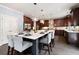 Gourmet kitchen featuring a large island with seating, custom cabinetry, and pendant lighting at 3045 Moss Stone Lane Sw Ln, Marietta, GA 30064