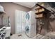 Well organized laundry room with front loading washer and dryer, shelving, and window at 3045 Moss Stone Lane Sw Ln, Marietta, GA 30064