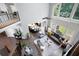 Open-concept living room with a high ceiling, large windows, and stylish furniture, including a gray sofa at 3045 Moss Stone Lane Sw Ln, Marietta, GA 30064