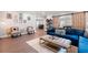 Spacious living room featuring decor, hardwood floors, and a comfortable blue velvet sectional sofa at 3045 Moss Stone Lane Sw Ln, Marietta, GA 30064
