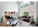 Open-concept living room flows seamlessly into a kitchen, with large windows offering verdant views at 3045 Moss Stone Lane Sw Ln, Marietta, GA 30064