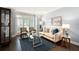 Cozy living room with a glass coffee table, neutral sofa, and large window at 3045 Moss Stone Lane Sw Ln, Marietta, GA 30064