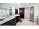Bright main bathroom boasts dual sinks, white marble floors, and a glass-enclosed shower at 3045 Moss Stone Lane Sw Ln, Marietta, GA 30064