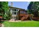 Backyard view highlighting a stone patio, screened porch, and spacious lawn at 4310 Granby Way, Marietta, GA 30062