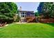 Green backyard featuring a stone patio, screened porch, and a well-maintained lawn at 4310 Granby Way, Marietta, GA 30062