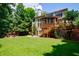 Spacious backyard with a lush lawn, patio seating, and a screened-in porch, perfect for entertaining at 4310 Granby Way, Marietta, GA 30062