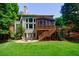 Large backyard with stone patio, screened porch, and manicured lawn offers outdoor living at 4310 Granby Way, Marietta, GA 30062