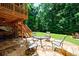Expansive backyard with a stone patio, outdoor furniture, and lush greenery, perfect for outdoor living at 4310 Granby Way, Marietta, GA 30062