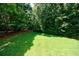 Expansive green backyard with mature trees offering ample space for outdoor activities at 4310 Granby Way, Marietta, GA 30062