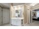 Bright bathroom featuring white vanity, beige wallpaper, and mirrored wall at 4310 Granby Way, Marietta, GA 30062